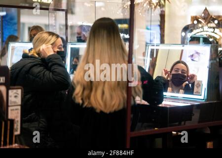 A woman sits at a beauty counter in Selfridges department store on Oxford Street, London on the first day of its reopening as England takes another step back towards normality with the further easing of lockdown restrictions. Picture date: Monday April 12, 2021. Stock Photo