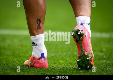 Turin, Italy. 11 April 2021. A tattoo on a leg of Danilo Luiz da Silva of Juventus FC depicting the UEFA Champions League trophy and the written '2016' and '2017' is seen during warm up prior to the Serie A football match between Juventus FC and Genoa CFC. Juventus FC won 3-1 over Genoa CFC. Credit: Nicolò Campo/Alamy Live News Stock Photo