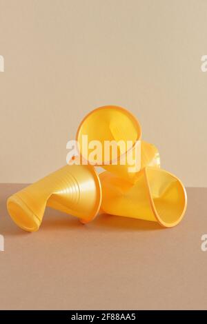 Crumpled empty plastic cups on monochrome background, isometric view, plastic waste, waste recycling, eco friendly packaging, sustainable industry con Stock Photo