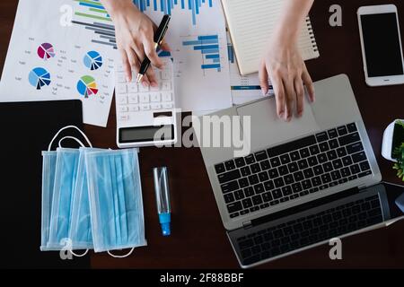 Work from home top view. Fund managers using calculator for analysis Investment stock market. Stock Photo