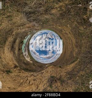 blue sky ball in middle of swirling field. Inversion of tiny planet transformation of spherical panorama 360 degrees. Curvature of space. Stock Photo