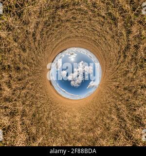 blue sky ball in middle of swirling field. Inversion of tiny planet transformation of spherical panorama 360 degrees. Curvature of space. Stock Photo