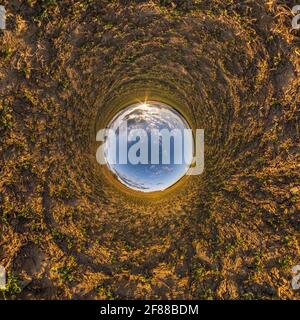 blue sky ball in middle of swirling field. Inversion of tiny planet transformation of spherical panorama 360 degrees. Curvature of space. Stock Photo