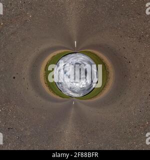 blue sky ball in middle of swirling field. Inversion of tiny planet transformation of spherical panorama 360 degrees. Curvature of space. Stock Photo