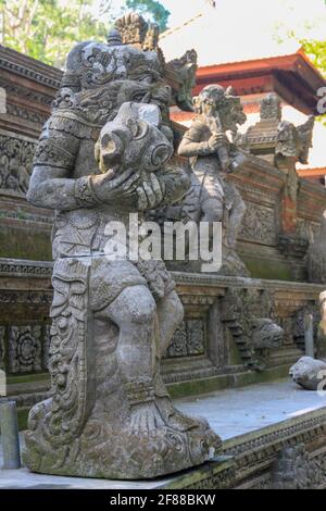 Traditional carved stone statues at Monkey Temple in Ubud, Bali, Indonesia Stock Photo