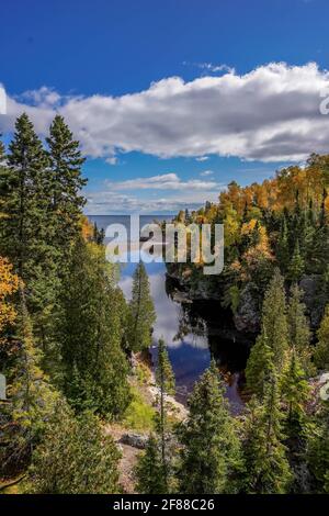 Autumn colored trees along the Baptism River where it meets Lake Superior at Tettegouche State Park, Minnesota. The north shore has a scenic drive. Stock Photo