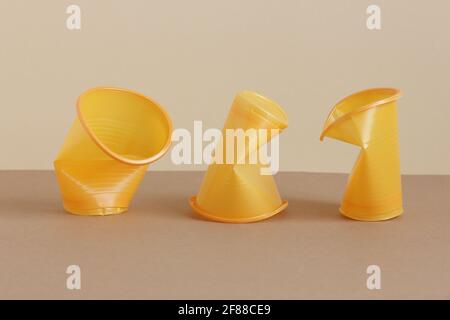 Crumpled empty plastic cups on monochrome background, isometric view, plastic waste, waste recycling, eco friendly packaging, sustainable industry con Stock Photo