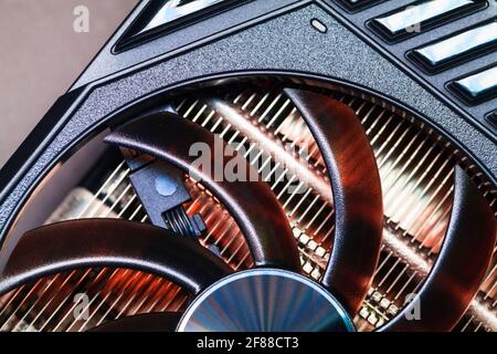 Shiny black GPU cooler fragment, close-up photo. This fan is mounted on a video card to cool the GPU Stock Photo