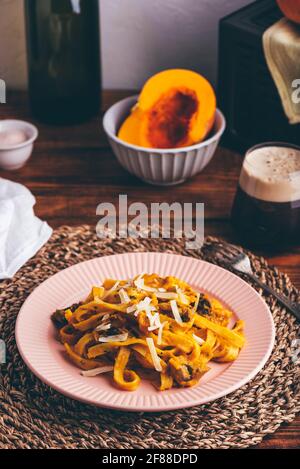 Portion of Pumpkin Pasta with Sour Cream and Mushrooms Stock Photo