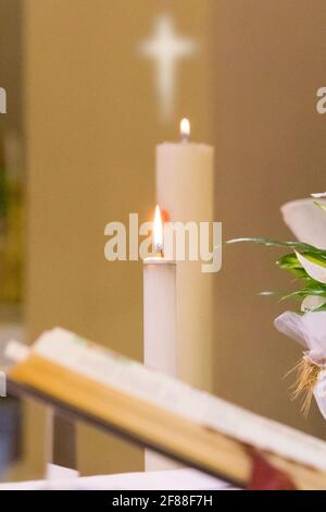 paschal candle with its light comes from the Holy Spirit and always accompanies the body of Christ Stock Photo