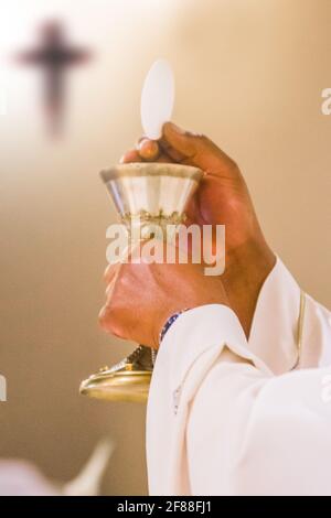 bread becomes the body of Christ in the hands of the pope, holy father, wine becomes blood Stock Photo