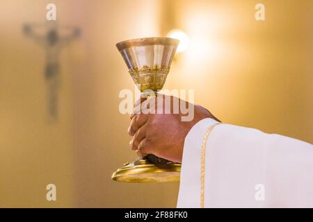 bread becomes the body of Christ in the hands of the pope, holy father, wine becomes blood Stock Photo