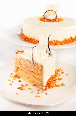 A styled cake and a piece of that cake in front of it. Stock Photo