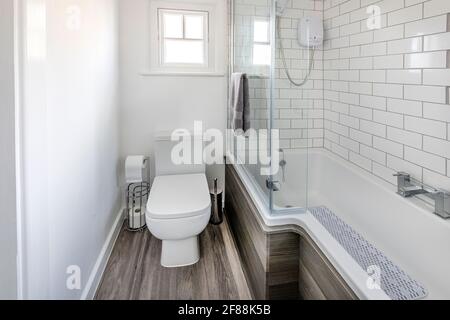 A modern bathroom with an over bath shower Stock Photo