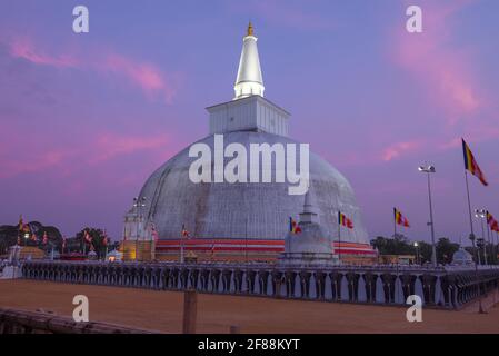 Ancient Dagoba of Ruwanwelisaya Stupa in purple twilight. Anuradhapura, Sri Lanka Stock Photo