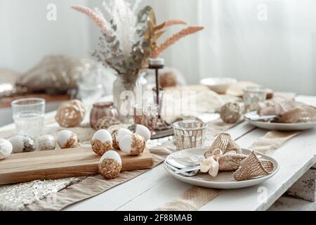 Cutlery and decorative items on the dining table for the Easter holiday. Stock Photo