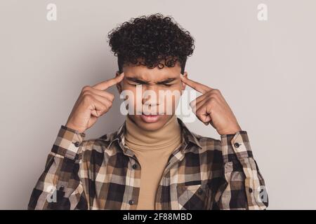 Photo of african minded guy hard think decide fingers temples wear checkered shirt isolated grey color background Stock Photo