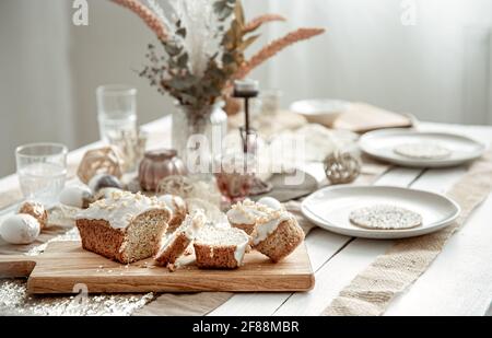 A festive table with a beautiful setting and freshly baked Easter cake. Stock Photo