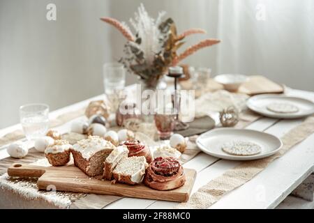 A festive table with a beautiful setting and freshly baked Easter pastries. Stock Photo