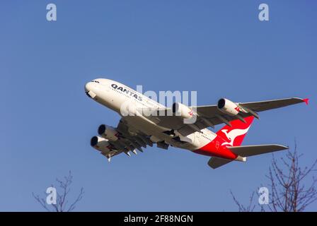 Qantas Airbus A380 -842 jet airliner plane VH-OQC taking off from London Heathrow Airport in blue sky. Climbing away. Space for copy