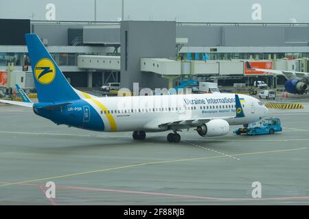 AMSTERDAM, NETHERLANDS - SEPTEMBER 30, 2017: Towing Boeing 737 (UR-PSR) Ukrainian International Airlines on the Schiphol Airport Stock Photo