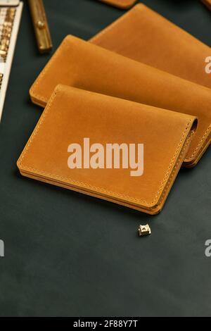 Handmade products made of genuine yellow and red leather. Leather passport cover, leather wallet. Leather goods for men. The view from the top. Stock Photo