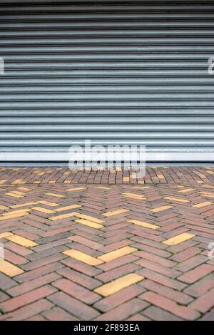 Detail of closed metal shutters on a shop front in the Netherlands Stock Photo
