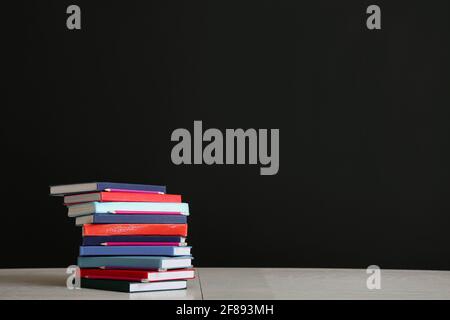 Stack of different books on dark background. Knowledge concept Stock ...