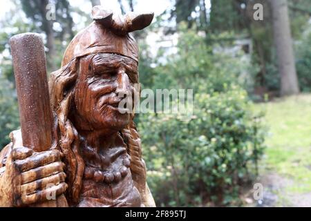 Wooden sculpture of Baba Yaga in Gurzuf Park in spring Stock Photo