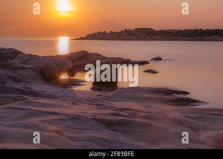 Silhouette of Holy Mount Athos, Greece at colorful sunrise or sunset and sea panorama Stock Photo