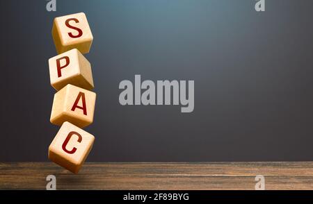 Wooden blocks with word SPAC. Special-purpose acquisition company. A easy way stock exchange financial instrument for attracting investments. Developm Stock Photo