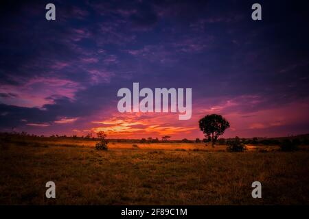 Evening colorful cloudy sky after the sunset with beautiful landscape. Stock Photo