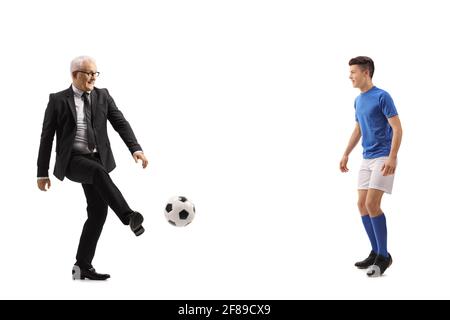 Full length profile shot of a mature businessman and a young footballer playing soccer isolated on white background Stock Photo