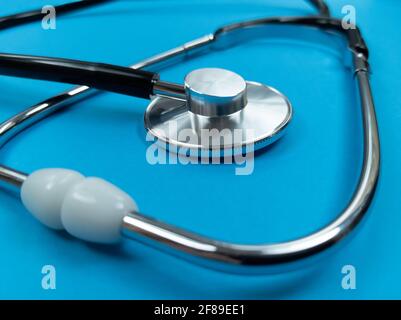 Black stethoscope on blue background. Stock photo. Stock Photo