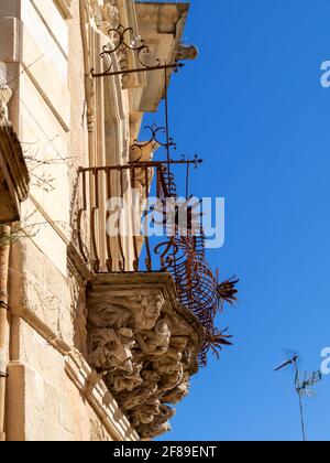 Side view of a stone carved balcony of the baroque Palazzo Cosentini, Ragusa Stock Photo