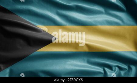 Bahamian flag waving in the wind. Close up of Bahamian banner blowing, soft and smooth silk. Cloth fabric texture ensign background. Use it for nation Stock Photo