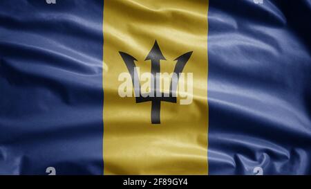 Barbadian flag waving in the wind. Close up of Barbados banner blowing, soft and smooth silk. Cloth fabric texture ensign background. Use it for natio Stock Photo