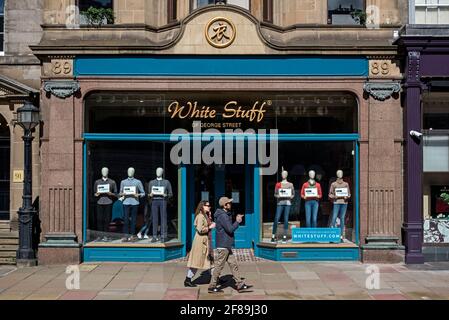 A couple walk past White Stuff on George Street, Edinburgh, Scotland, UK. Stock Photo