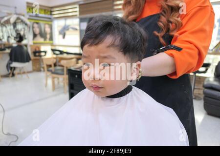 Asian cute baby boy getting hair cut (korean baby) Stock Photo