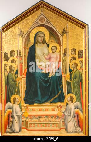 Florence, Italy.  Madonna Enthroned, also known as the Ognissanti Madonna, is a painting by the Italian late medieval artist Giotto di Bondone, in the Stock Photo