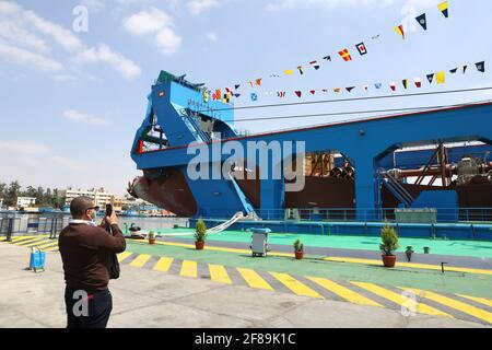Ismailia, Egypt. 12th Apr, 2021. A man takes photos of a large cutter suction dredger (CSD) on Timsah Lake in Ismailia, Egypt, on April 12, 2021. Egypt's Suez Canal Authority (SCA) celebrated on Monday the recent arrival of the large cutter suction dredger (CSD). Credit: Ahmed Gomaa/Xinhua/Alamy Live News Stock Photo
