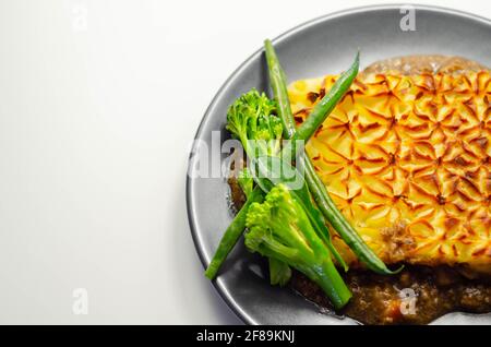 Tender minced lamb with garden veg in a hearty gravy beneath butter mash, typical Shepherd's pie, traditional british meal Stock Photo