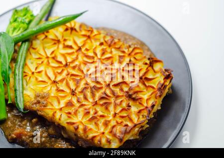 Tender minced lamb with garden veg in a hearty gravy beneath butter mash, typical Shepherd's pie, traditional british meal Stock Photo