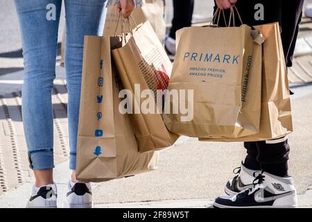 Shoppers with Primark  shopping bags, London, UK Stock Photo