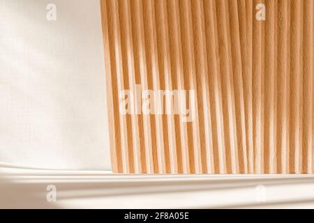 Podium for cosmetic product presentation from wooden natural material. Monochrome background Stock Photo
