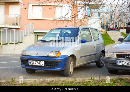 POZNAN, POLAND - Apr 01, 2016: Parked gray Fiat Seicento car by apartment buildings Stock Photo