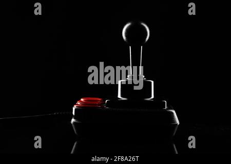 Retro joystick from 8-bit consoles. Game controller isolated on black background Stock Photo