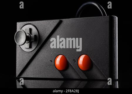 Retro joystick from 8-bit consoles. Game controller isolated on black background Stock Photo