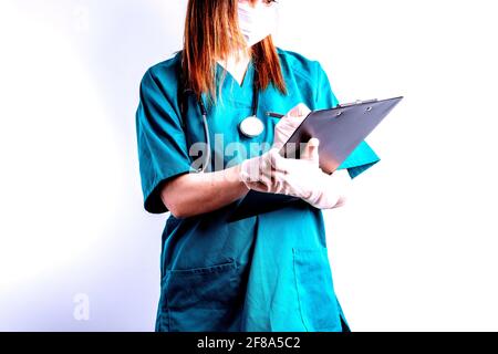 young beautiful woman with stethoscope gloves writing a report by hand. concept report for surgery. Stock Photo