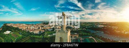 Aerial panoramic view of Sanctuary of Christ the King or Santuario de Cristo Rei at sunset. Christ Statue in Lisbon, Portugal. Stock Photo